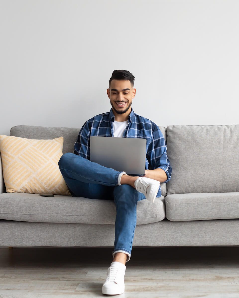 portrait-of-smiling-arab-man-using-laptop-at-home-2022-10-07-02-34-51-utc-e1668133197900.jpg